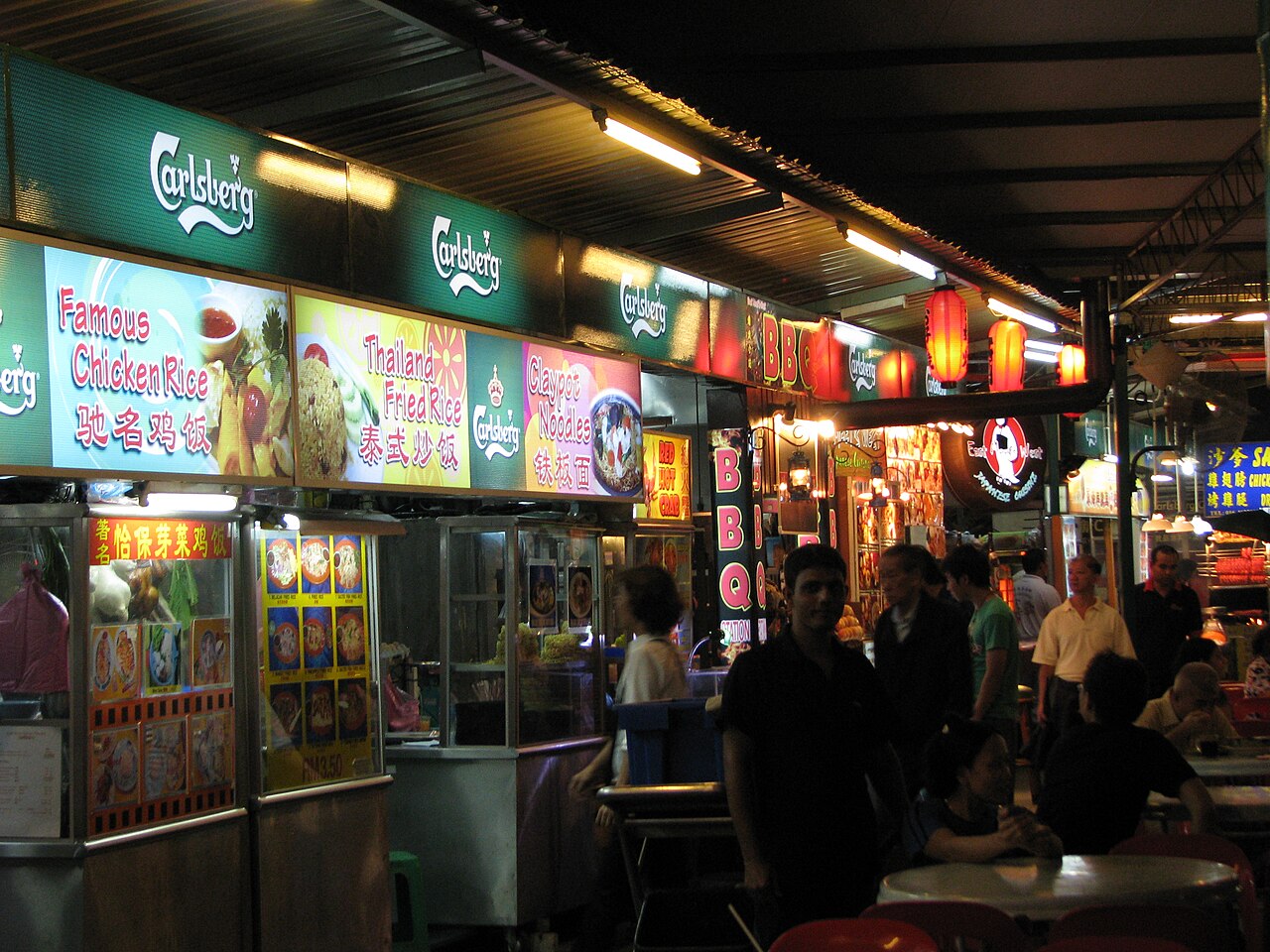 Local diners and hawker stalls at a Penang food court in the evening