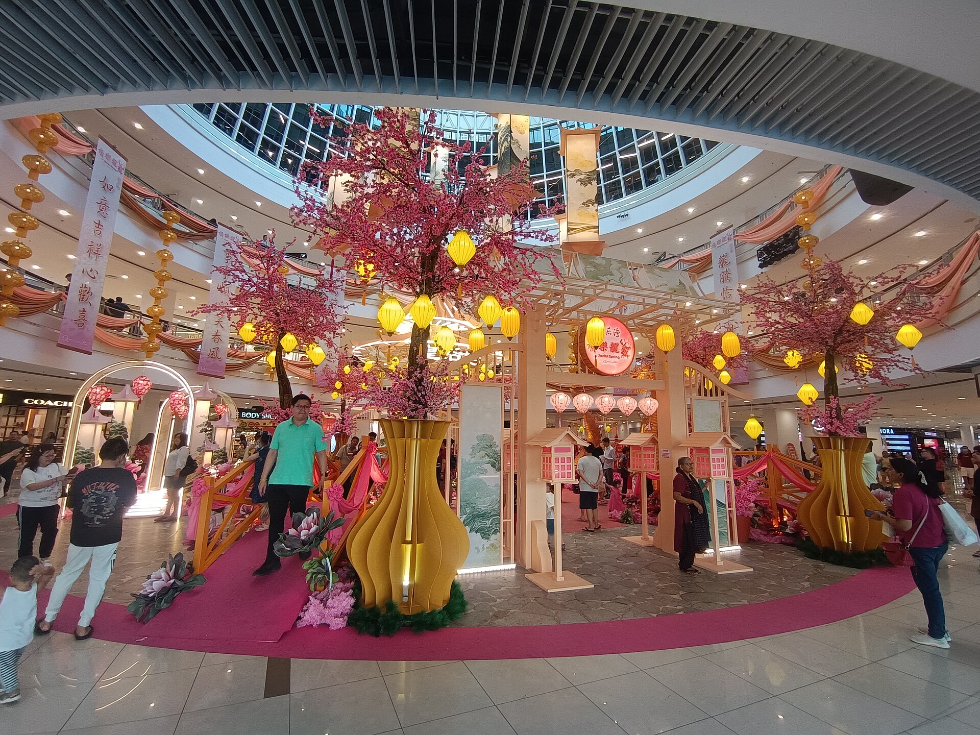 Local shoppers walking through Queensbay Mall in Bayan Lepas
